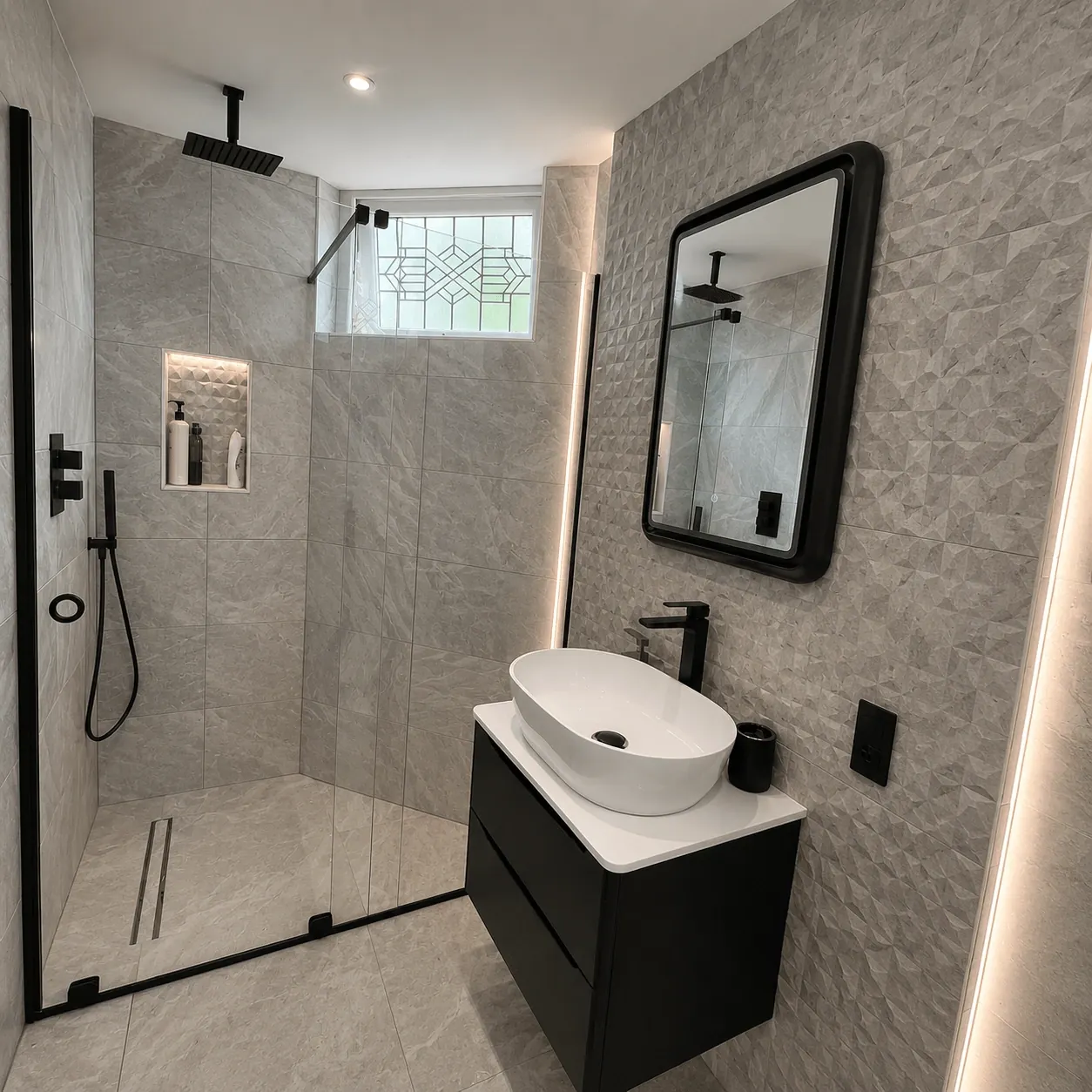 Walk-in shower with a black-framed screen, recessed shelf and compact vanity