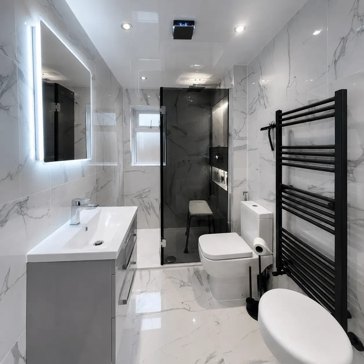 Long marble-effect bathroom with a vanity, bath and shower at the far end
