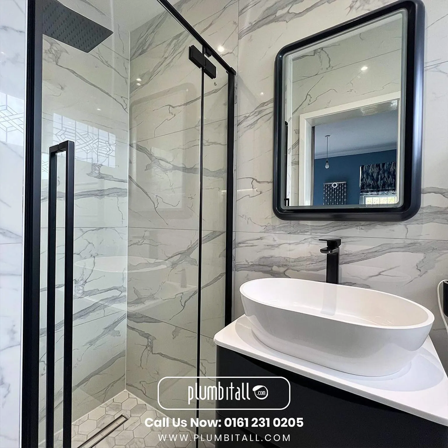 Countertop basin and black-framed mirror beside a marble-effect shower enclosure