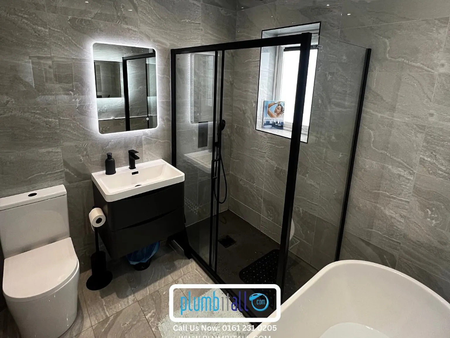 Family bathroom with a black-framed shower enclosure and compact vanity
